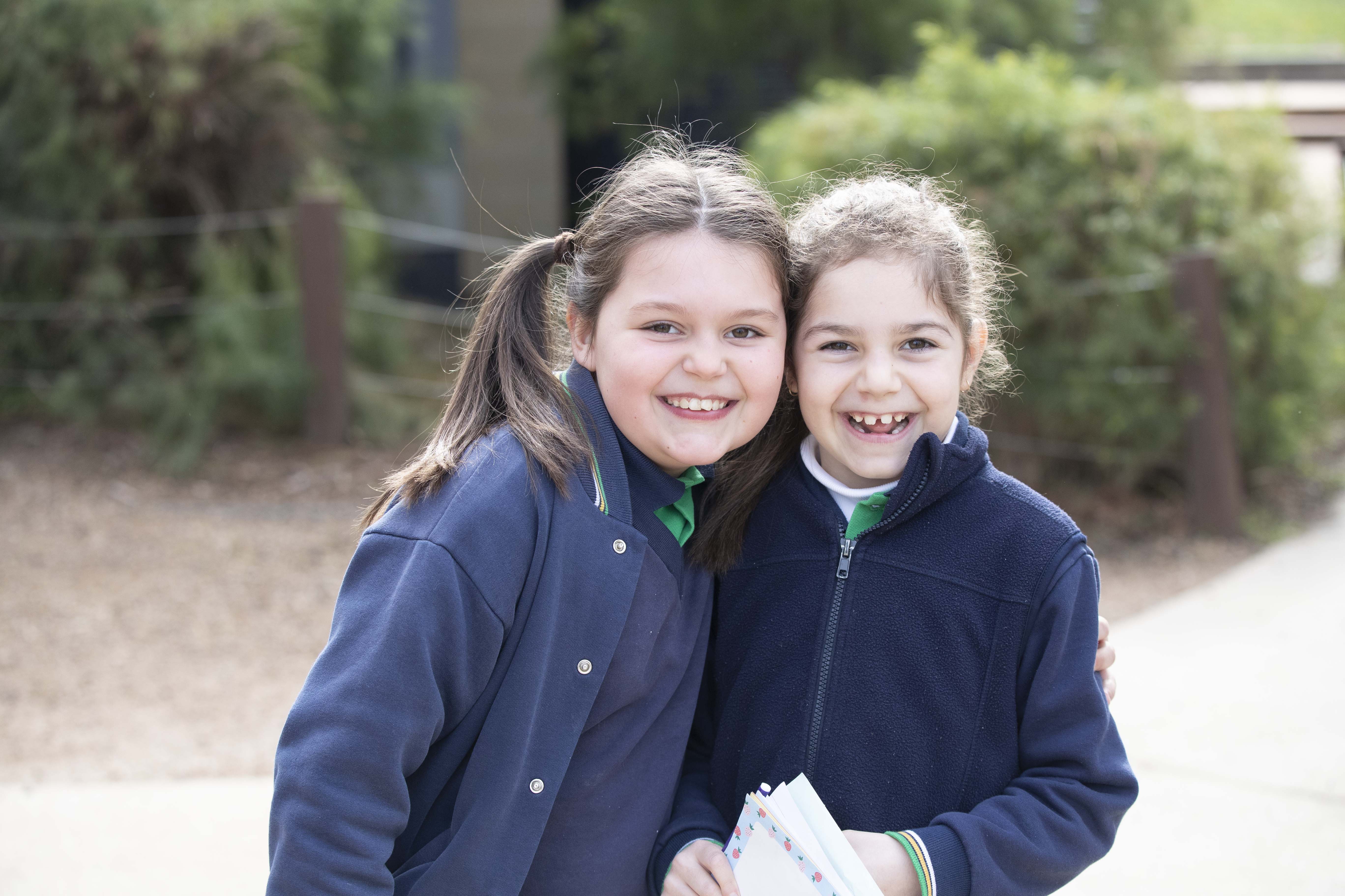 Two children smiling at the camera