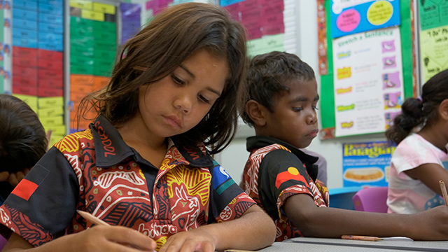 Two children working in a classroom