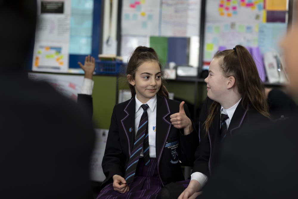 Two adolescents in a classroom