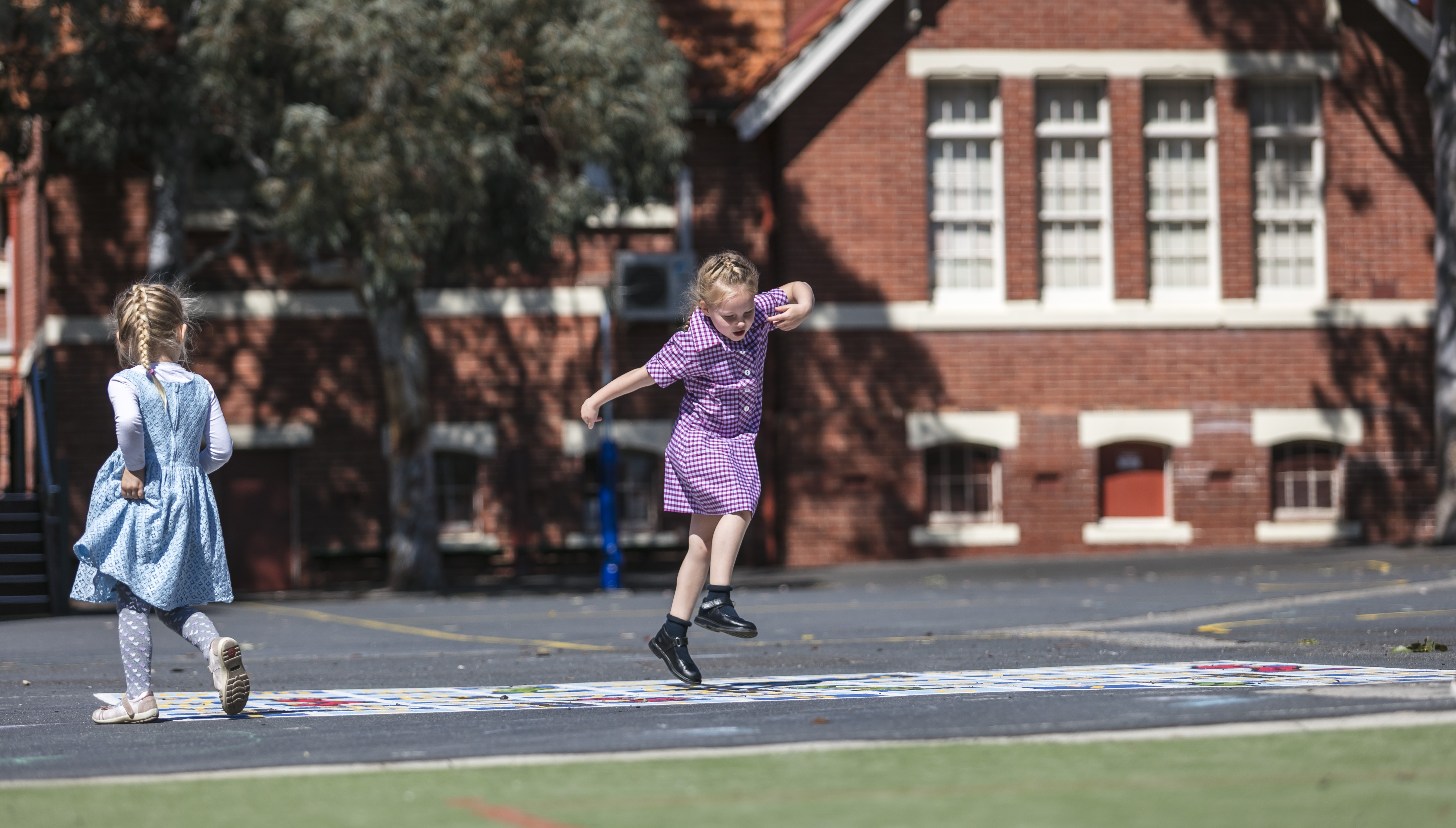 Two young children playing in the playground